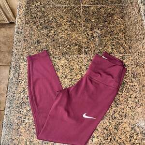 Nike Women's Dri-FIT Mid-Rise 7/8 Running Leggings in Burgundy